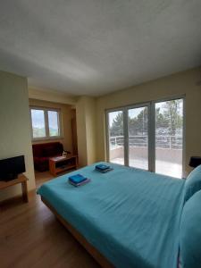 a bedroom with a large bed with two towels on it at PS Apartments - Peshtani in Peštani