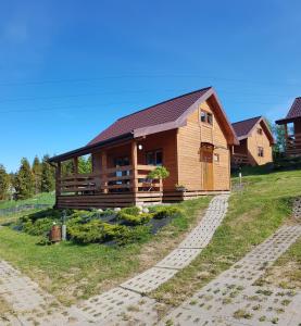 a large wooden house on top of a hill at AGA Domek na Kaszubach in Sławki