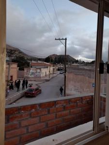 a view of a street with a red car at HOSPEDAJE DE NORTE A SUR in Tilcara