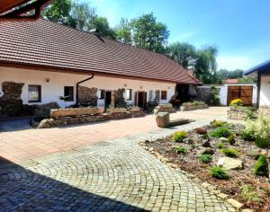 a house with a brick walkway in front of it at Statek Ctiboř in Ctiboř