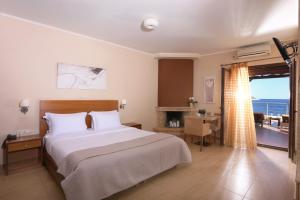 A bed or beds in a room at Faros Luxury Suites