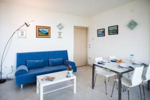 a living room with a blue couch and a table at Italian Vacation Homes - Longol in Riva di Solto +21 photos