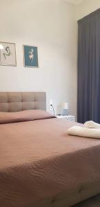 a bedroom with a large bed with orange sheets at Apt22 stylish apartment close of Heraklion center in Heraklio Town