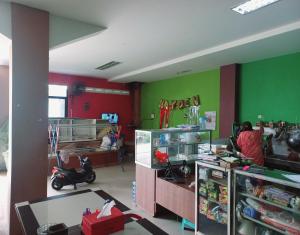 una habitación con paredes verdes y una persona en una habitación en SPOT ON 91336 Guesthouse Tarumanegara en Karawang