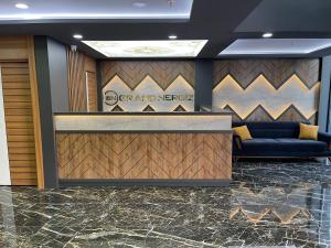 a lobby with a reception desk and a blue couch at Grand Nergiz Otel in Antalya +54 photos