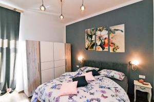 a bedroom with a bed with pink pillows at Apartment Carissima-Direct on sea, Lovran-Opatija in Lovran