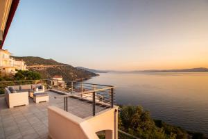 a balcony with a view of the water at Sea Whisper Villa in Peloponnese in rkadiko Chorio
