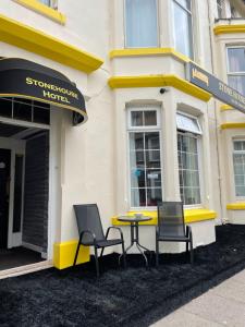 a table and chairs in front of a building at The Stone House Hotel in Blackpool
