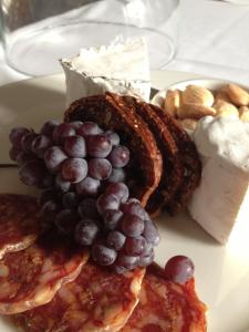 a plate of food with grapes and cheese and bread at Embrace Calistoga in Calistoga