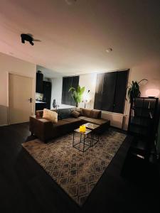 a living room with a couch and a table at Canal apartment at historic CityCenter Amersfoort in Amersfoort