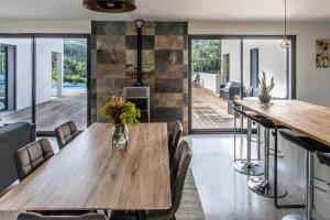 a dining room with a wooden table and chairs at Villa Blanche, Contemporary, Cathars, Couiza, Carcassonne in Couiza