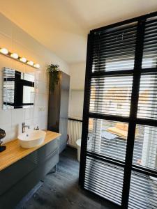 a bathroom with a sink and a large window at Canal apartment at historic CityCenter Amersfoort in Amersfoort