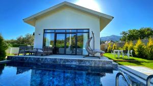 a villa with a swimming pool and a house at Honeymoon Villa in Gocek in Göcek