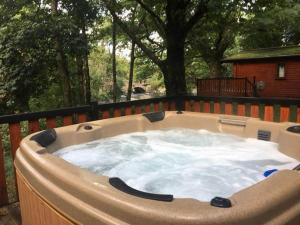 a large hot tub sitting on a deck at L09 - The Snowdon Spa with Hot Tub in Bethesda