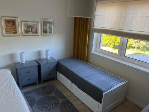 a bedroom with a bed and two night stands at Apartament U Kucharzy Łysica 2 in Wilków