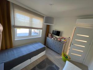 a small bedroom with a blue bed and a window at Apartament U Kucharzy Łysica 2 in Wilków +15 photos