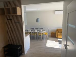 a kitchen and living room with a table and chairs at Apartament U Kucharzy Łysica 2 in Wilków