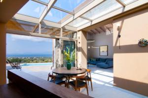 an open living room with a table and chairs at Villas Mandalos in Paleros