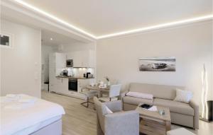 a white living room with a couch and a table at Baltic in Binz