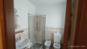 a bathroom with a sink and a toilet and a shower at Villa Cristina in Pontelatone