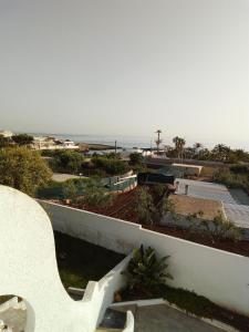 a white bench sitting on top of a building with the beach at Villa Anna Maria in Polignano a Mare