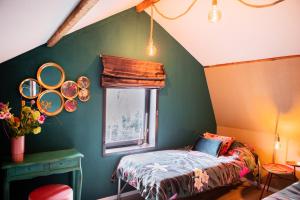 Tempat tidur dalam kamar di Bosserheide