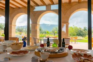 a table with food on it in a building with windows at Hotel Mas de la Costa **** in Valderrobres