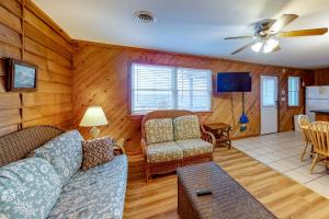 a living room with a couch and chairs and a table at The Sea Salt Cottage at Geri's Place 304 in Nags Head