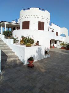 a white house with stairs and plants in front of it at Villa Anna Maria in Polignano a Mare