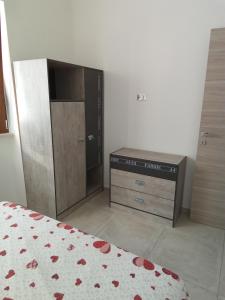 a bedroom with a bed and a dresser in a room at Villa Anna Maria in Polignano a Mare