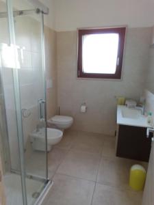 a bathroom with a toilet and a sink and a shower at Villa Anna Maria in Polignano a Mare