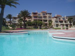 a large swimming pool in front of some apartments at Norus Las Tacas in Las Tacas