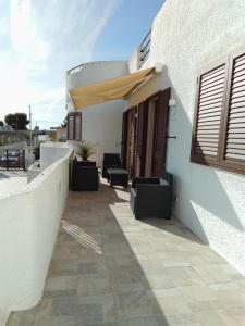 a patio with chairs and an umbrella on a building at Villa Anna Maria in Polignano a Mare