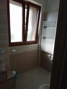 a bathroom with a shower with a window and a sink at Villa Anna Maria in Polignano a Mare