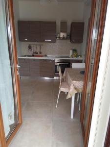 a kitchen with a table and a table and a table and chairs at Villa Anna Maria in Polignano a Mare