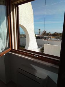 a window with a view of a building at Villa Anna Maria in Polignano a Mare