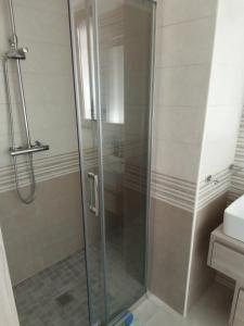 a shower with a glass door in a bathroom at Villa Anna Maria in Polignano a Mare