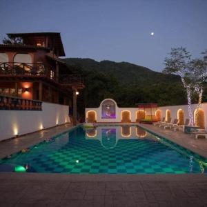 a large swimming pool in a building with a building at Amaria Villas in Puerto Vallarta
