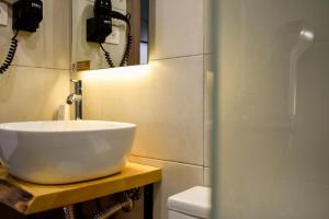 a bathroom with a sink and a mirror at Entelia in Skiathos