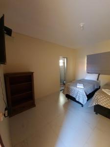 Postel nebo postele na pokoji v ubytování Pousada Quatro Estações
