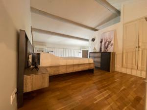 a bedroom with a bed and a television in it at Gîte Douceur de Provence in Maubec