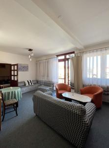 a living room with two couches and a table at 2- izbový APARTMÁN KAJKA v PENZION TRSTENÁ in Trstená