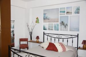a bedroom with a bed and two chairs at Casa Clio in Favignana +15 photos