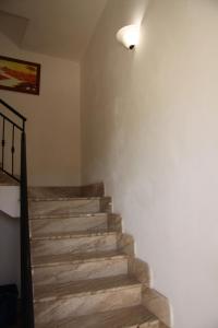 a staircase in a room with a light on the wall at Casa Clio in Favignana