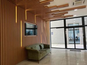 a living room with a couch and a tv on a wall at Liana Sea&Sky Deluxe in Batumi