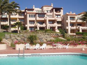 a resort with a swimming pool and a building at Norus Las Tacas in Las Tacas