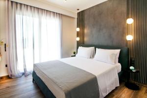 Postel nebo postele na pokoji v ubytování Villas Mandalos