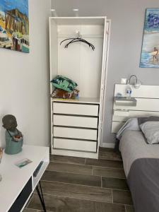 a bedroom with a bed and a white dresser at Laniakea in Lacanau-Océan