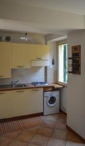 a kitchen with a sink and a washing machine at Da Sid in Tremezzo +14 photos