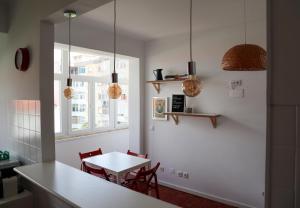 a kitchen with a table and chairs and a window at Ana's Guesthouse in Sintra